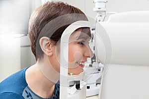 Smiling Woman Patient Having a refractor Exam